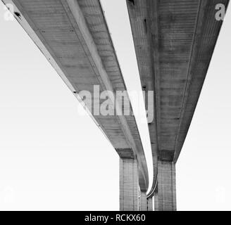 View from underneath large scale road bridge, black and white Stock Photo