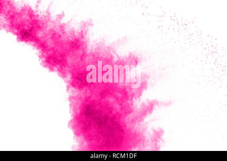 Abstract pink powder explosion on white background. Freeze motion of pink dust splattered. Stock Photo