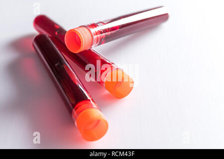 Test tubes with blood on white table with test chart and ballpoint pen Stock Photo