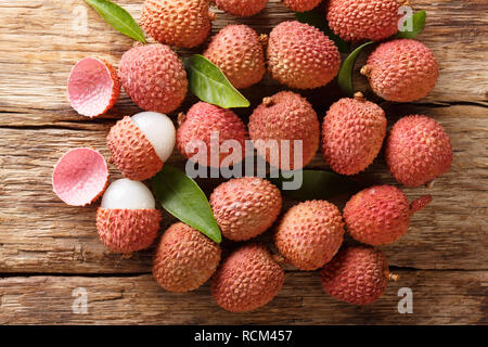 litchi, lichee, lychee, or lichi, Litchi chinensis on old rustic wood background with copy space. horizontal top view from above Stock Photo