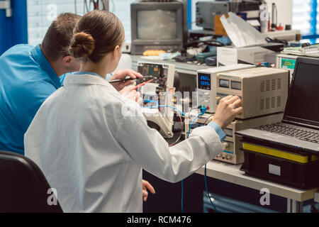 Team of electronic engineers testing a product prototype Stock Photo