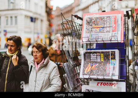 PARIS, FRANCE - OCT 28, 2017: Womens next to French international newspaper Liberation with news from Spain about the Catalonia Referendum and protests in Barcelona - kiosk stand in city  Stock Photo