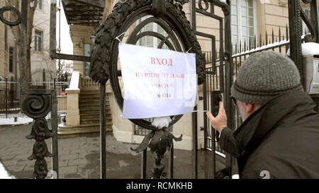 STRASBOURG, FRANCE - MAR 18, 2018: Pooling station text on paper at Russian presidential election 2018 with senior Russian male entering the gate of Consulate General of the Russian Federation to vote for President Stock Photo