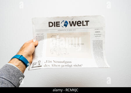PARIS, FRANCE - MAR 15, 2018: POV at German Die Welt newspaper with caricature of Stephen Hawking wheelchair of the English theoretical physicist, cosmologist  Stock Photo