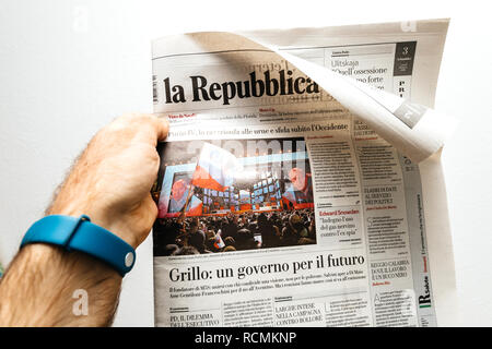 PARIS, FRANCE - MAR 19, 2017: Man reading Italian La Republica newspaper at press kiosk featuring Russian presidential election from 2018 with the winner Vladimir Putin Stock Photo