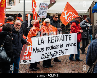 STRASBOURG, FRANCE  - MAR 22, 2018: At retirement we want to live with dignity - seniors with banner at demonstration protest against Macron French government string of reforms Stock Photo