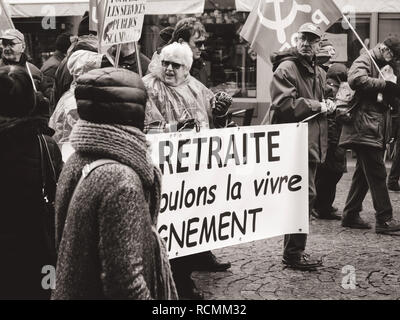 STRASBOURG, FRANCE  - MAR 22, 2018: At retirement we want to live with dignity - seniors with banner at demonstration protest against Macron French government string of reforms Stock Photo