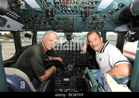 MIAMI, FL - NOVEMBER 17: Captain 'Sully' Sullenberger and Co-pilot Jeff Skiles pose with the Historical 1958 DC7 for a benefit hosted by Historical Flight Foundation. Chesley Burnett 'Sully' Sullenberger, III (born January 23, 1951) is a retired airline captain and aviation safety consultant. He was hailed as a national hero in the United States when he successfully executed an emergency water landing of US Airways Flight 1549 in the Hudson River off Manhattan, New York City, after the aircraft was disabled by striking a flock of Canada geese during its initial climb out of LaGuardia Airport o Stock Photo