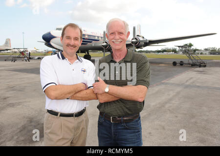 MIAMI, FL - NOVEMBER 17: Captain 'Sully' Sullenberger and Co-pilot Jeff Skiles pose with the Historical 1958 DC7 for a benefit hosted by Historical Flight Foundation. Chesley Burnett 'Sully' Sullenberger, III (born January 23, 1951) is a retired airline captain and aviation safety consultant. He was hailed as a national hero in the United States when he successfully executed an emergency water landing of US Airways Flight 1549 in the Hudson River off Manhattan, New York City, after the aircraft was disabled by striking a flock of Canada geese during its initial climb out of LaGuardia Airport o Stock Photo