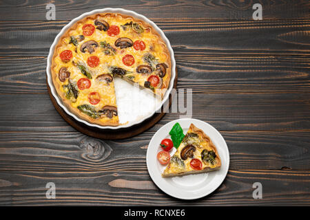 Slice of traditonal homemade spinach chicken quiche tart or pie on plate Stock Photo