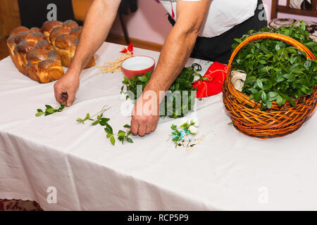 Green leaves are periwinkle in a basket on the table 2019 Stock Photo
