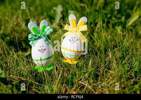 Easter eggs cute bunny on trendy pink background. Funny decoration. Happy Easter Handmade Springtime. Holiday background.Festive concept.Easter bunny decoration.DIY holiday handicraft of colorful rabbits Stock Photo