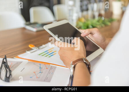 Businessman using tablet to check financial report Stock Photo