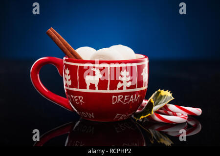 Gingerbread cookie men in a hot cup of cappuccino. Stock Photo