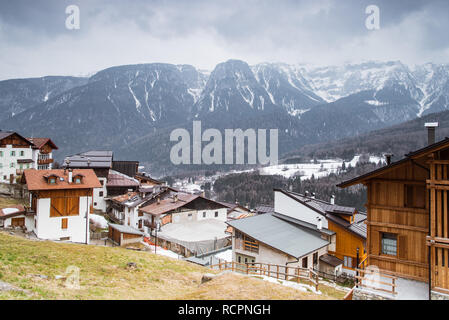 Italian houses in a small mountain town Deggiano in Ski region Val di Sole, Brenta Dolomites snow-covered mountains, Trento, Trentino Alto Adige Italy Stock Photo