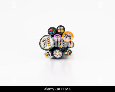 Cross-section of various electric cables, isolated on a white background with a clipping path. Stock Photo
