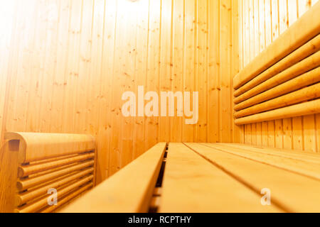 Interior of Finnish sauna, classic wooden sauna, Finnish bathroom. Wooden sauna cabin. Wooden room. Sauna steam. Soft lighting Stock Photo