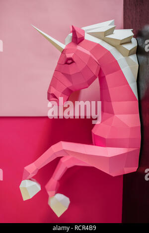 Paper unicorn head on a colored background. Geometry, bright and pastel