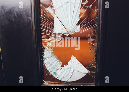 Broken glass black door of the shop. Stock Photo