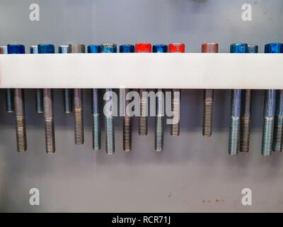 A white shelf custom made for screws of different length Stock Photo