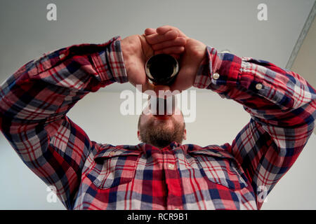 man with beer mug in hand on white background Stock Photo
