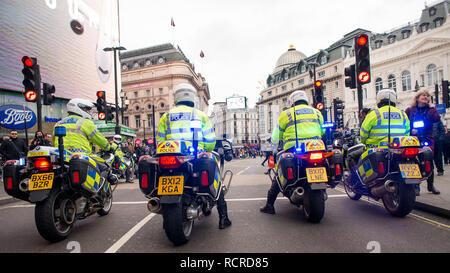 Police motorcycle riders, escort and clear the roads ahead of any traffic for a planned street demonstration through the streets of central London,UK. Stock Photo