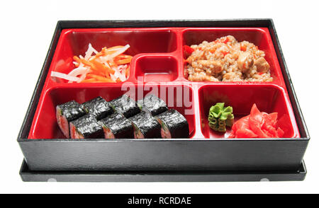 Bento lunch in the box. Set - sushi rolls, salad, pilaf, meat, sauce and wasabi. Isolated on white background. Stock Photo