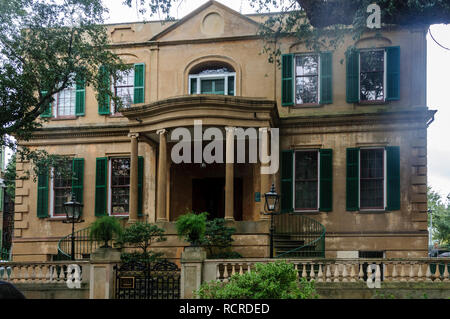 Savannah, GE: 10/19/18: Green shutters and grand front porch are found on an old-fashioned house with traditional design in Savannah, GA Stock Photo