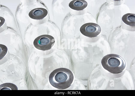 Used medical phials with metal caps. Medical bottles. Stock Photo