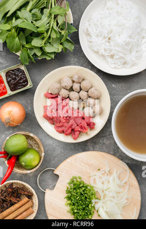 Traditional vietnamese noodle soups pho in bowls, concrete background. Vietnamese beef soup pho bo, Close-up. Asian/vietnamese food. Vietnamese dinner