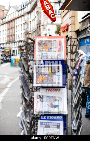 PARIS, FRANCE - OCT 28, 2017: French international newspaper with news from Spain about the Catalonia Referendum and protests in Barcelona - tabac kiosk stand in city  Stock Photo