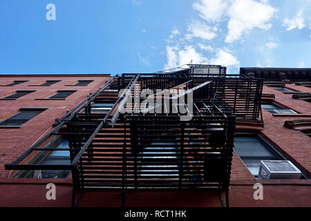 Metal fire escape stairs on exterior of brick building in Brooklyn, New York Stock Photo