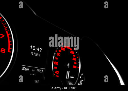 Close up shot of a speedometer in a car. Car dashboard. Dashboard details with indication lamps.Car instrument panel. Dashboard with speedometer, tach Stock Photo