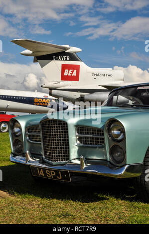 Vintage plane and car. Classic airliner BEA Hawker Siddeley Trident Two and BOAC Cunard Vickers VC10. 1960 Facel Vega HK500 classic French vehicle Stock Photo