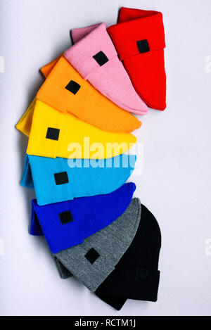 Knitted beanie hats. Colorful clothes items. Top view, copy space. Advertising discount space. Stock Photo