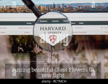 MONTREAL, CANADA - JUNE 4, 2016 : Harvard University page under magnifying glass. Harvard University is a private research university in Cambridge, Ma Stock Photo
