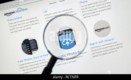 MONTREAL, CANADA - MAY 8, 2016 : Amazon Cloud Drive web page under magnifying glass. Amazon Cloud Drive is a web storage application from Amazon. Stock Photo