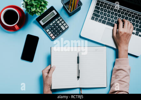 Business woman hands with pen writing notebook  on office desk table close up. Business concept. Stock Photo