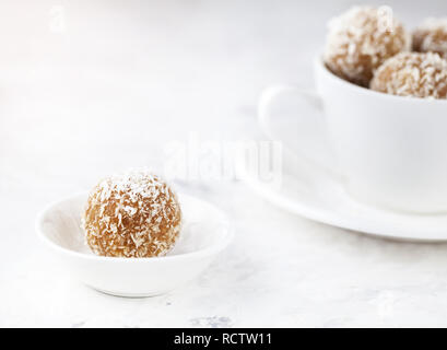 Indian Besan Ladoo sweets with coconut flakes close up on white background Stock Photo