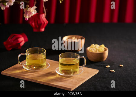 Lunar new year food and drink still life on black background. Translation of text paper in image: Prosperity Stock Photo