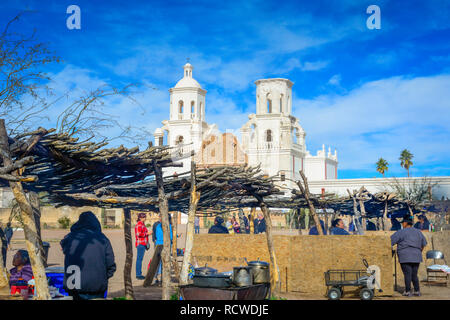 Native American food vendors cook outside for tourists visiting the historical Mission San Xavier del Bac, a Spanish Catholic Mission near Tucson, AZ Stock Photo