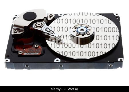 Computer hard drive, opened, read-write head on the disk, binary numbers reflected in the disc, symbolic image Stock Photo