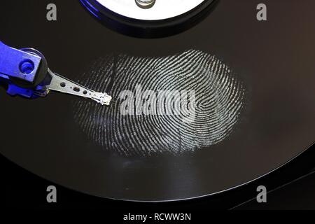 Computer hard drive, opened, read-write head on the disk, fingerprint on the disc, digital fingerprint, symbolic image Stock Photo