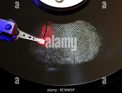 Computer hard drive, opened, read-write head on the disk, fingerprint on the disc, digital fingerprint, symbolic image Stock Photo