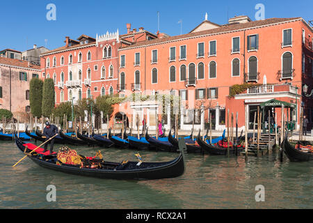 Venice, Italy - March 22, 2018: Venetian gondolier riding gondola at Grand Canal in Venice. Stock Photo