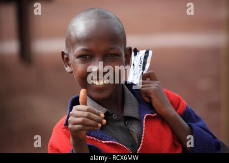 Boy, smiling, holding up his thumb, portrait, Tanzania, Africa Stock Photo