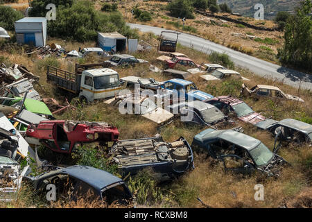 Old rusty corroded cars in car scrapyard Stock Photo