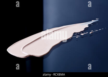 the texture of a foundation liquid. Black background. Stock Photo