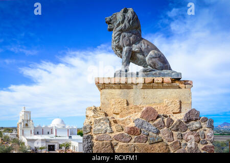 An old guardian lion sculpture on the grounds At the historical Mission San Xavier del Bac, a Spanish Catholic Mission near Tucson, AZ Stock Photo