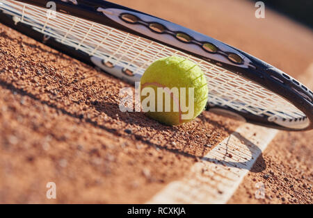 Tennis balls and racket on the court Stock Photo